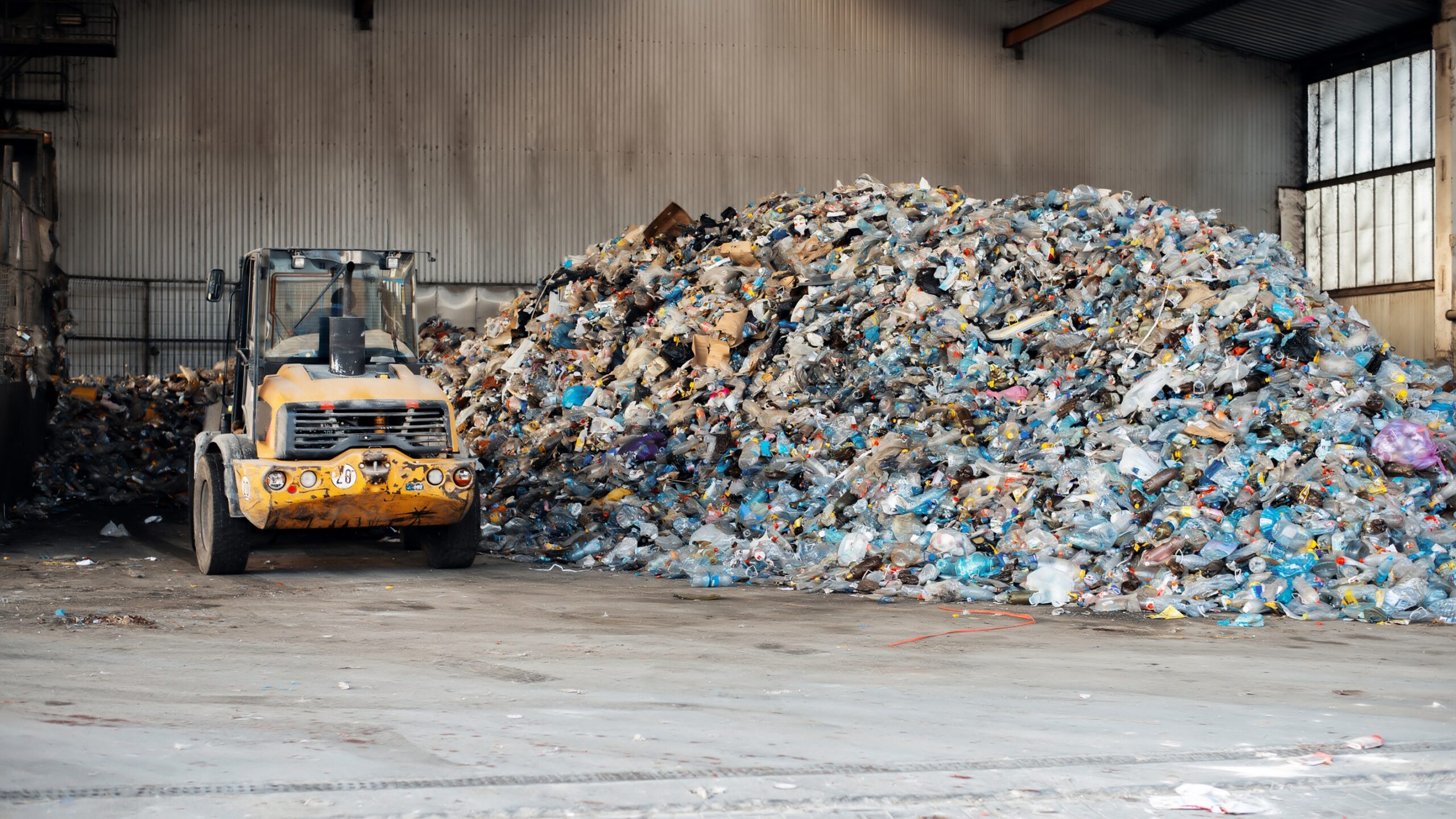 Heap of plastic garbage at waste sorting plant